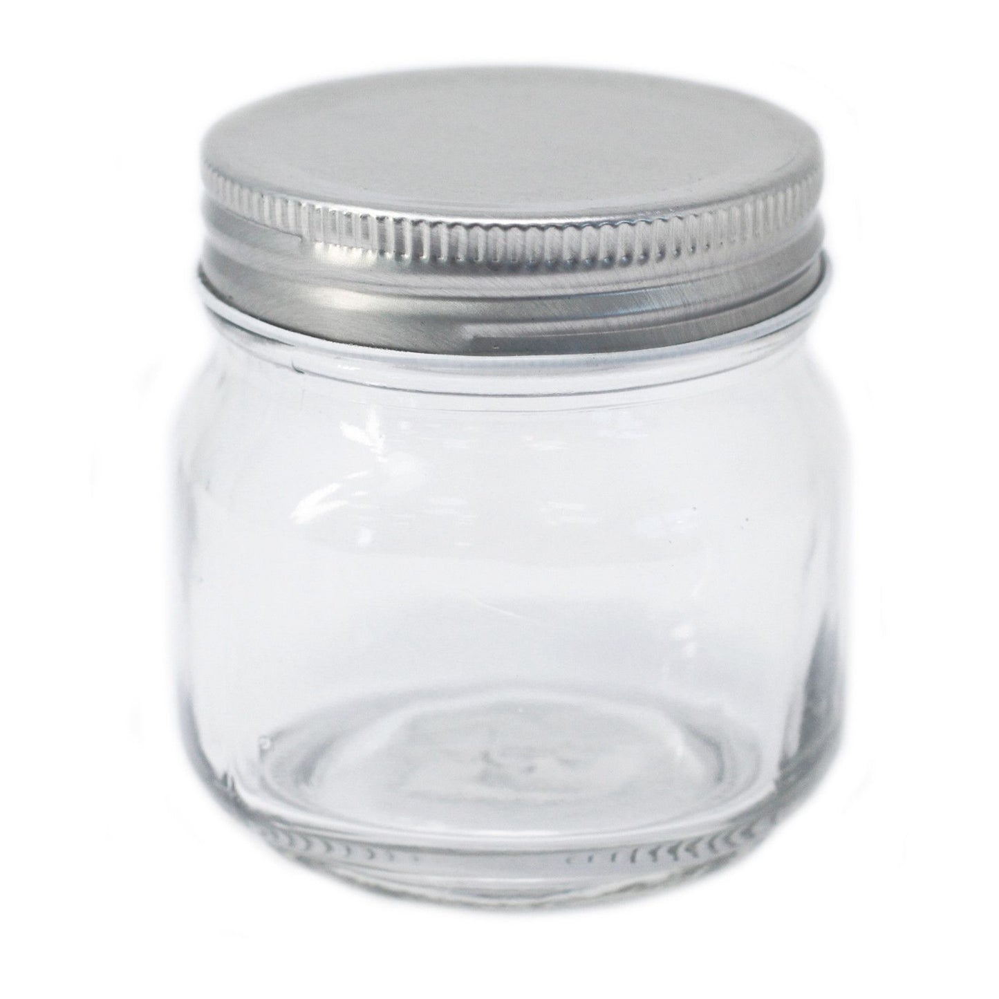 Clear square glass jar with four flat sides and a silver twist-off metal lid on a plain background.