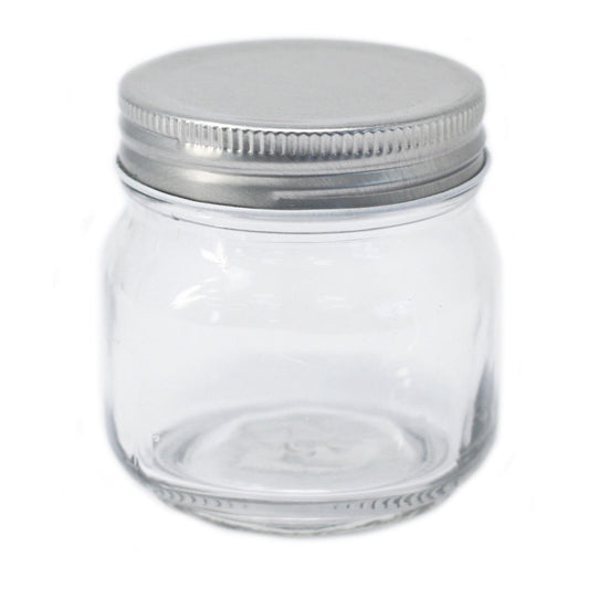 Clear square glass jar with four flat sides and a silver twist-off metal lid on a plain background.