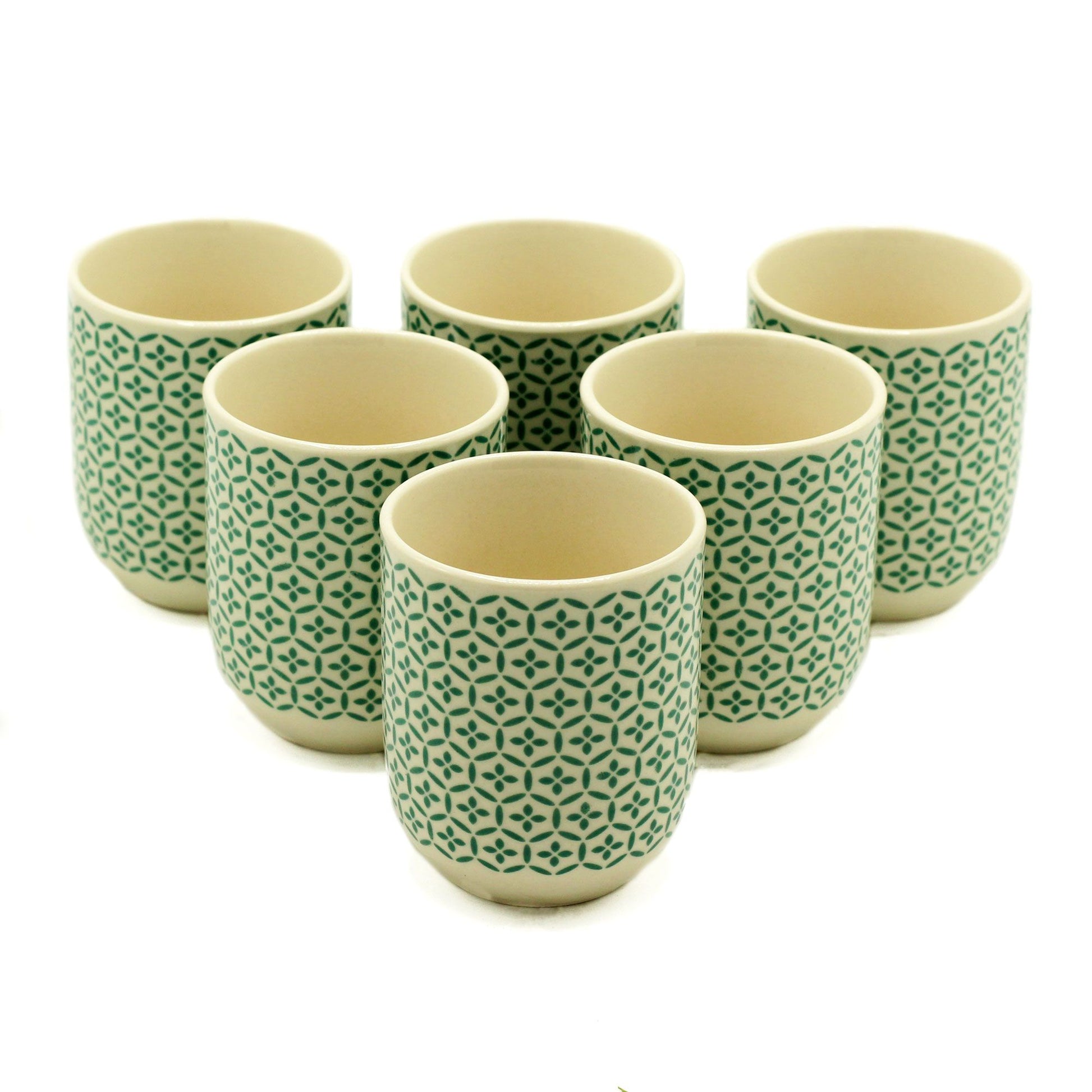 Two petite handleless ceramic tea cups featuring a vibrant green mosaic pattern on a white background.