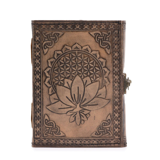 Antique grey leather notebook featuring an embossed lotus mandala design with hand-stitched edges on a wooden surface.