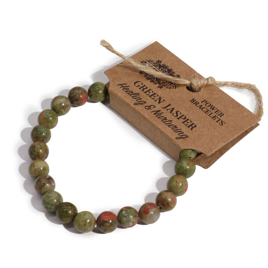 Stretch power bracelet featuring smooth, round green jasper gemstone beads with unique natural patterns.