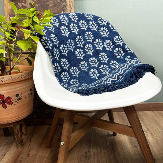 Handmade indigo blue cotton throw featuring a delicate white floral chhota flower pattern with artisan stitched details.
