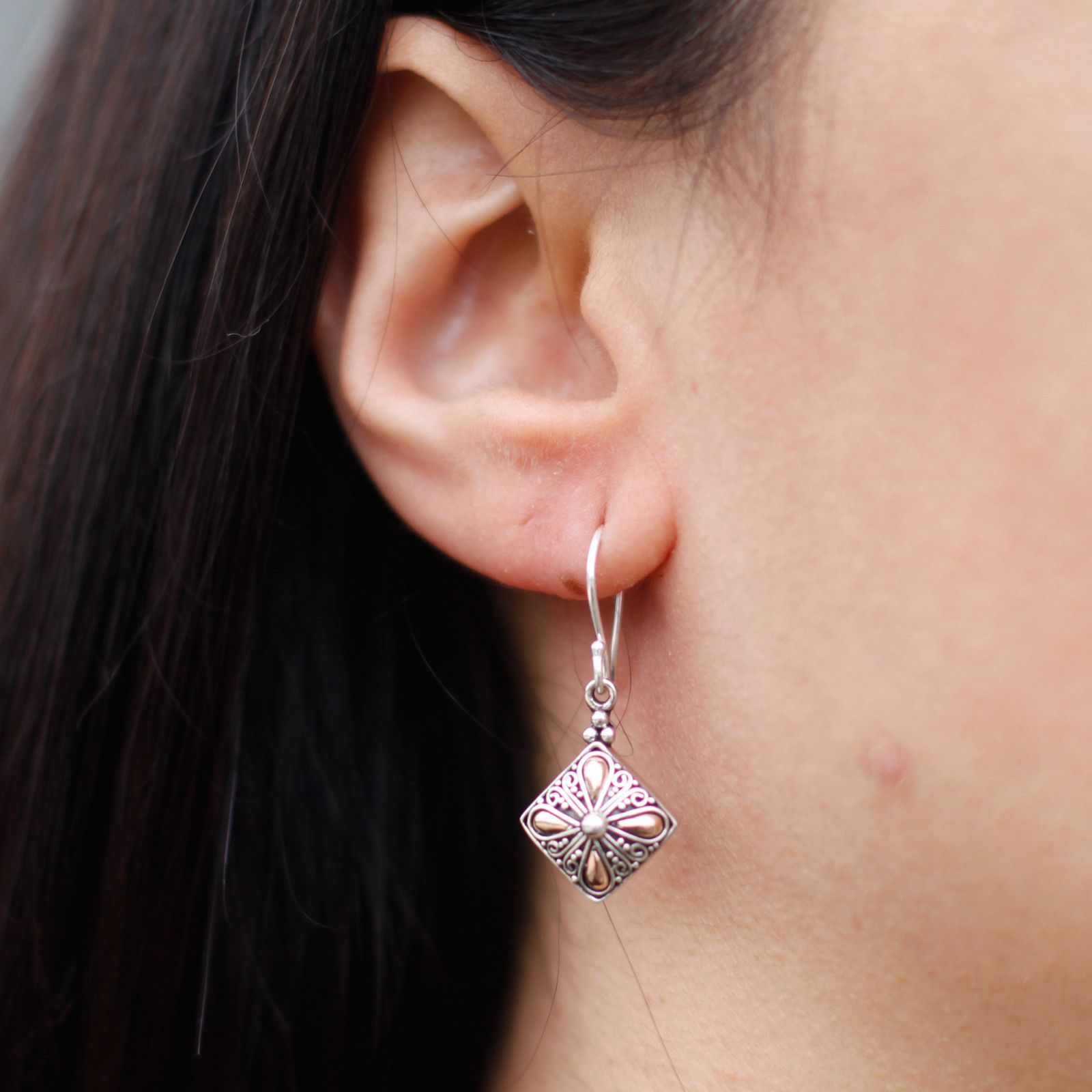 Elegant mixed metal drop earrings featuring a square design in silver and gold tones.