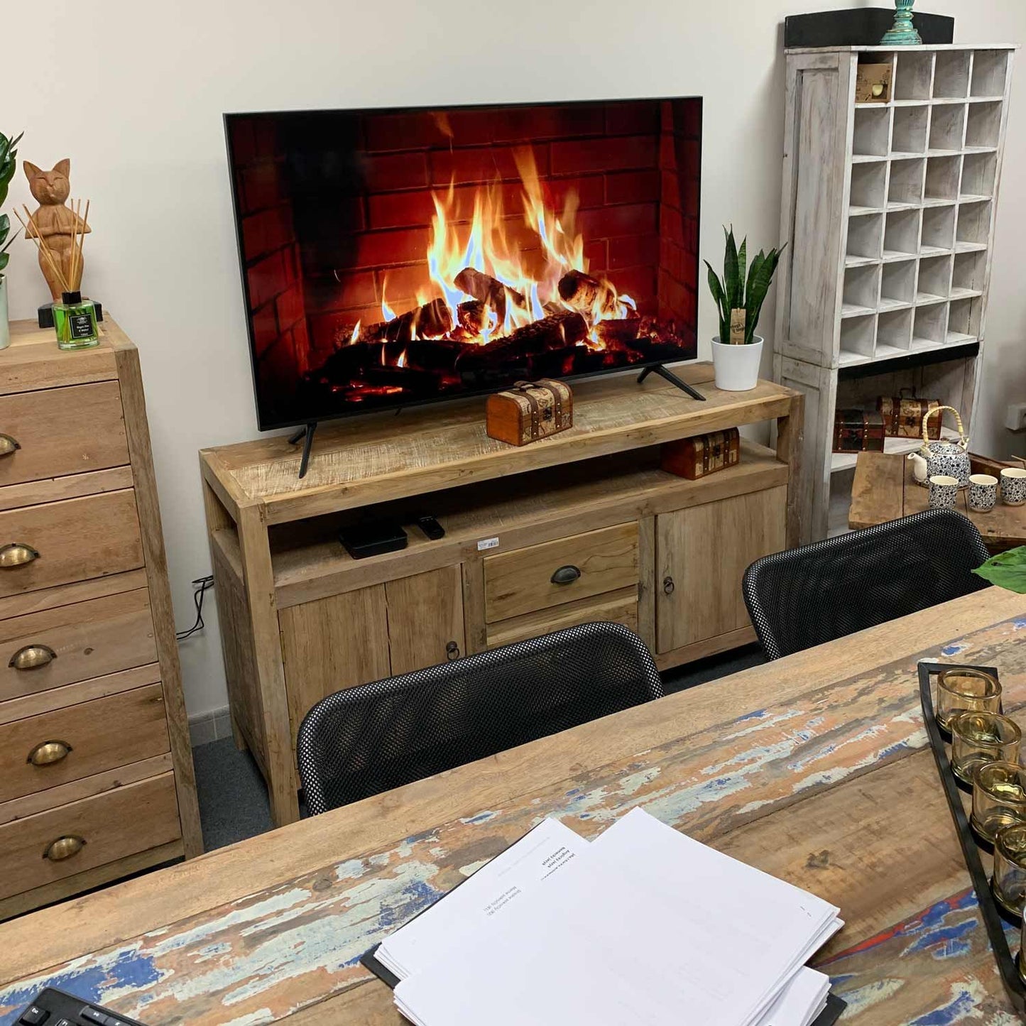 Large rustic TV stand handcrafted from reclaimed teak wood with unique multi-toned wood grain and storage drawers.
