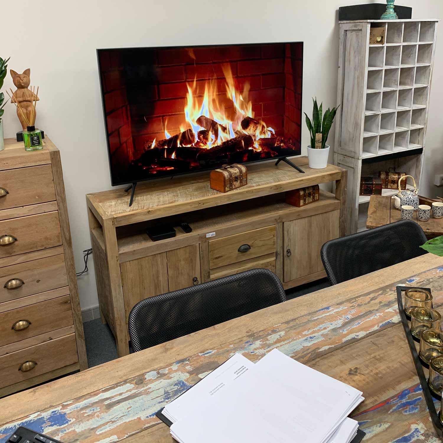 Large rustic TV stand handcrafted from reclaimed teak wood with unique multi-toned wood grain and storage drawers.