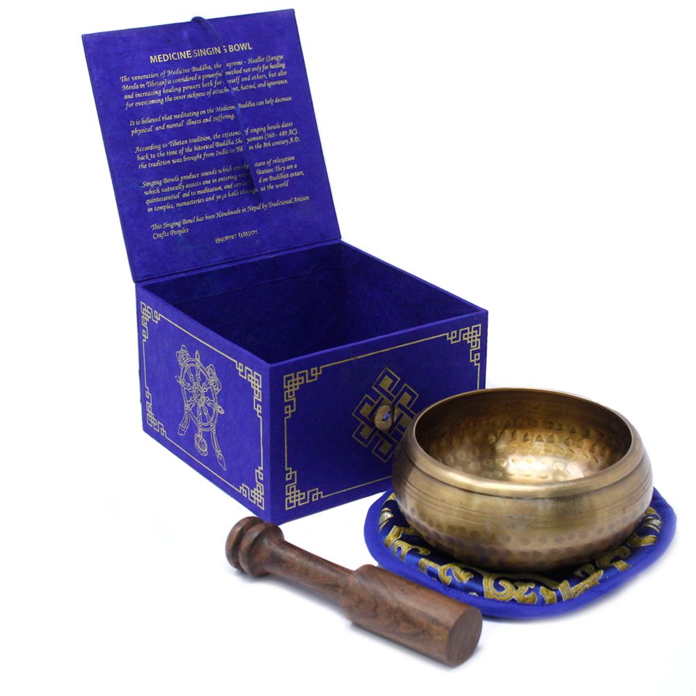 Handcrafted 10cm brass singing bowl with intricate Medicine Buddha engravings, complete with a wooden striker and cushion.