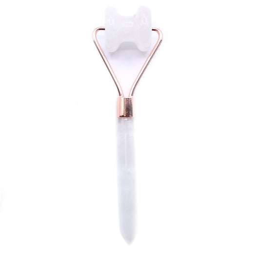Clear rock quartz gemstone facial roller designed specifically for sculpting the jawline with a silver metal frame.