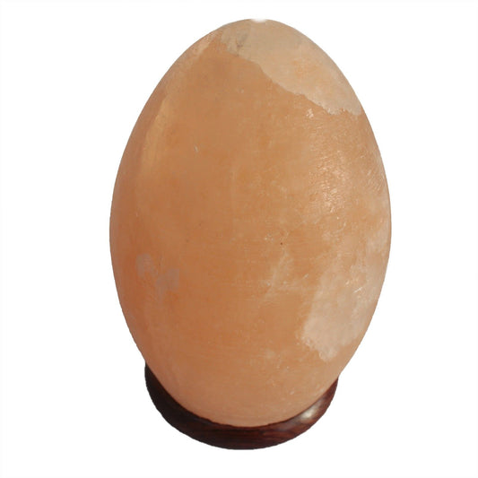 Smooth egg-shaped pink Himalayan salt lamp sitting on a circular dark wood base, emitting a warm orange glow.