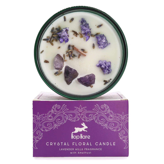 Soy wax candle in a glass jar topped with purple lavender flowers and a raw purple Amethyst gemstone.