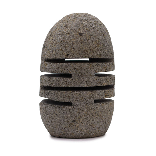 Hand-carved natural riverstone candle holder with a unique layered standing stone design and cut-out openings for light.