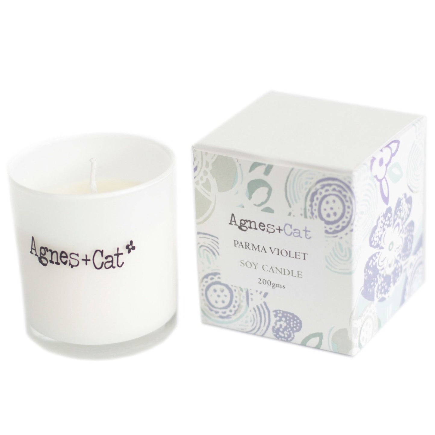Small purple votive candle in a simple glass jar, featuring a clean white label and natural soy wax.