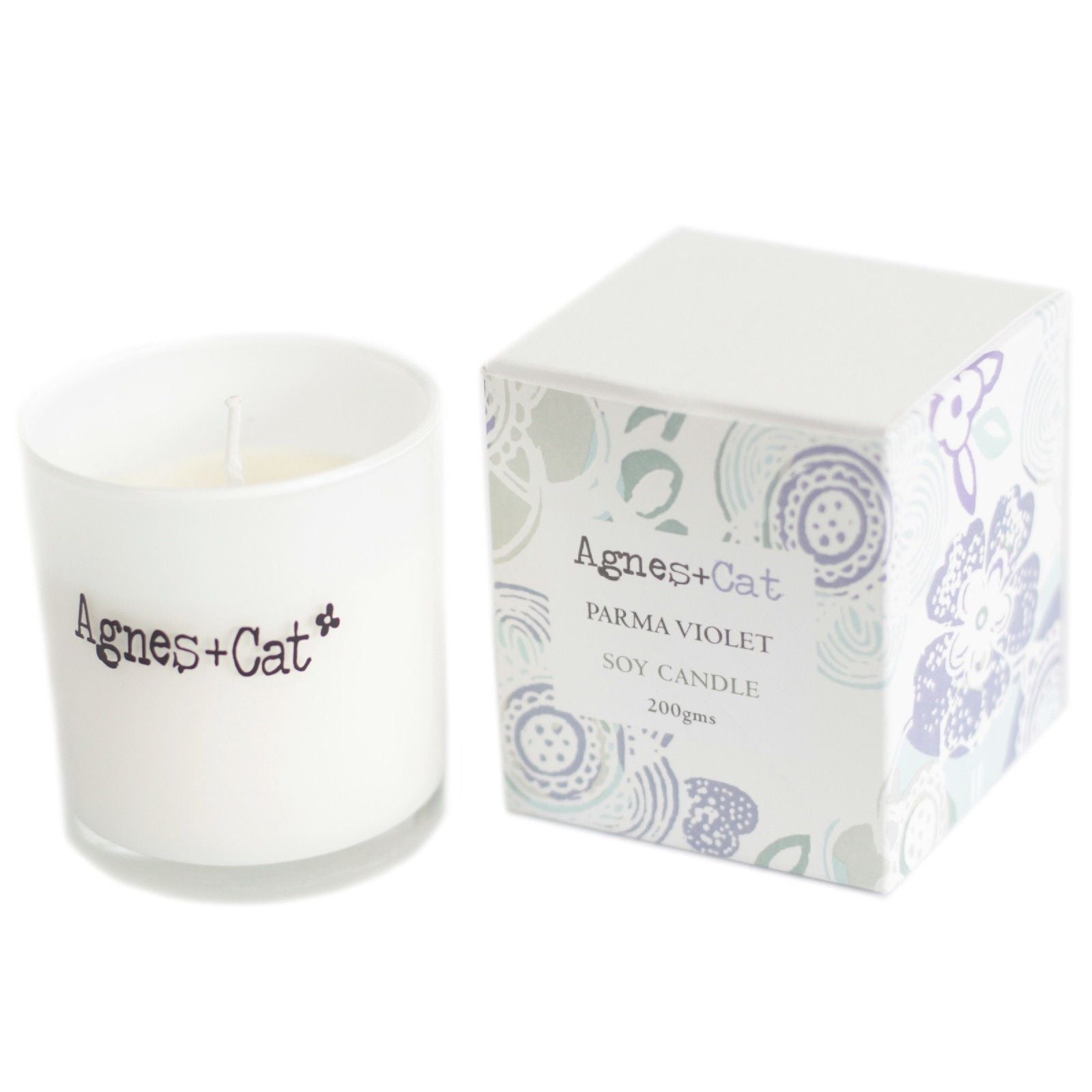 Small purple votive candle in a simple glass jar, featuring a clean white label and natural soy wax.