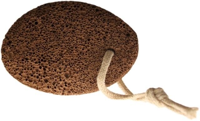 Natural grey oval-shaped volcanic lava foot stone for exfoliating dry skin.