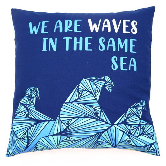 Square cotton cushion cover featuring a printed wave design in grey, blue, and natural cream colours.