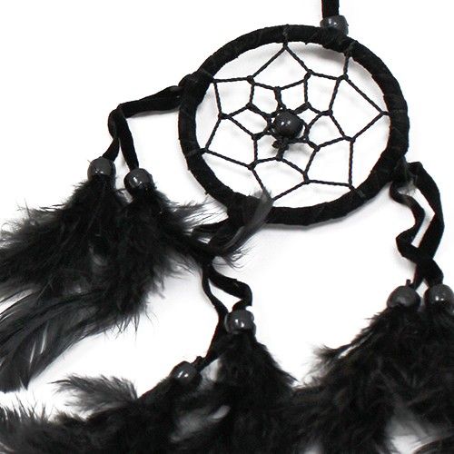 Small round handmade Bali dreamcatcher featuring black, white, and red threads with delicate hanging feathers.