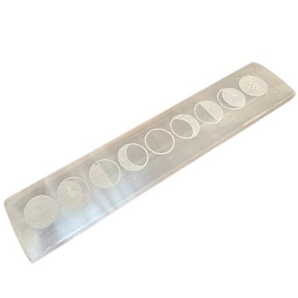 Rectangular white selenite charging plate engraved with lunar moon cycle phases on a flat bar surface.