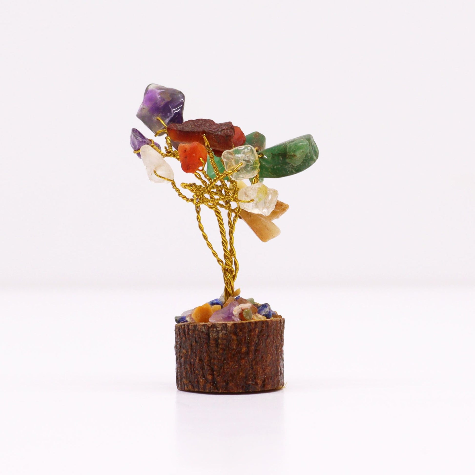 Small handcrafted gemstone tree with colourful multi-stone leaves on a rustic natural wood base.