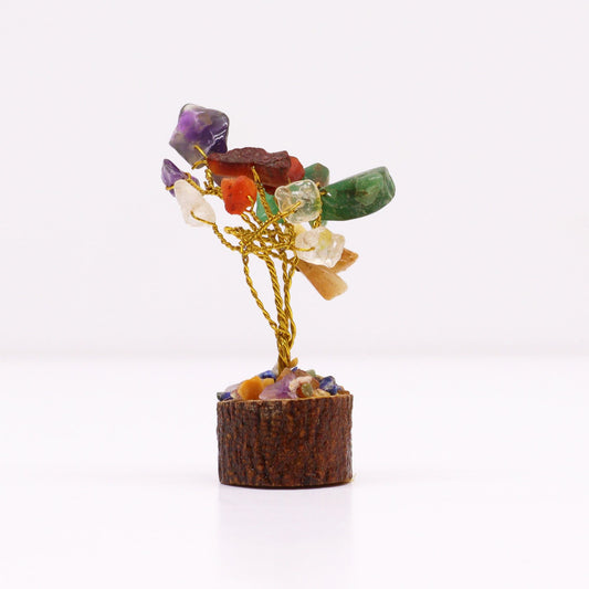 Small handcrafted gemstone tree with colourful multi-stone leaves on a rustic natural wood base.