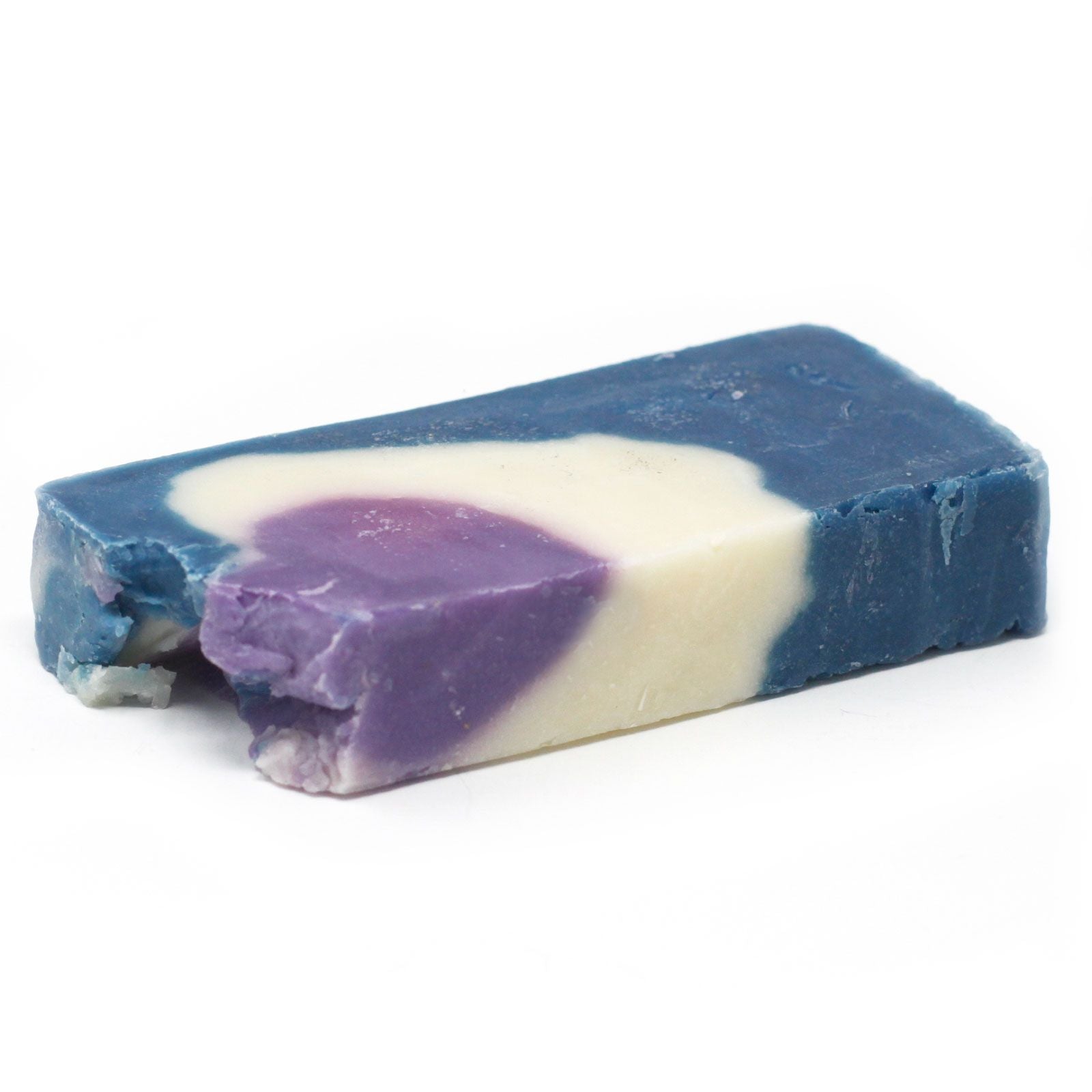 Handcrafted slice of green herbal olive oil soap with dried botanicals on top.