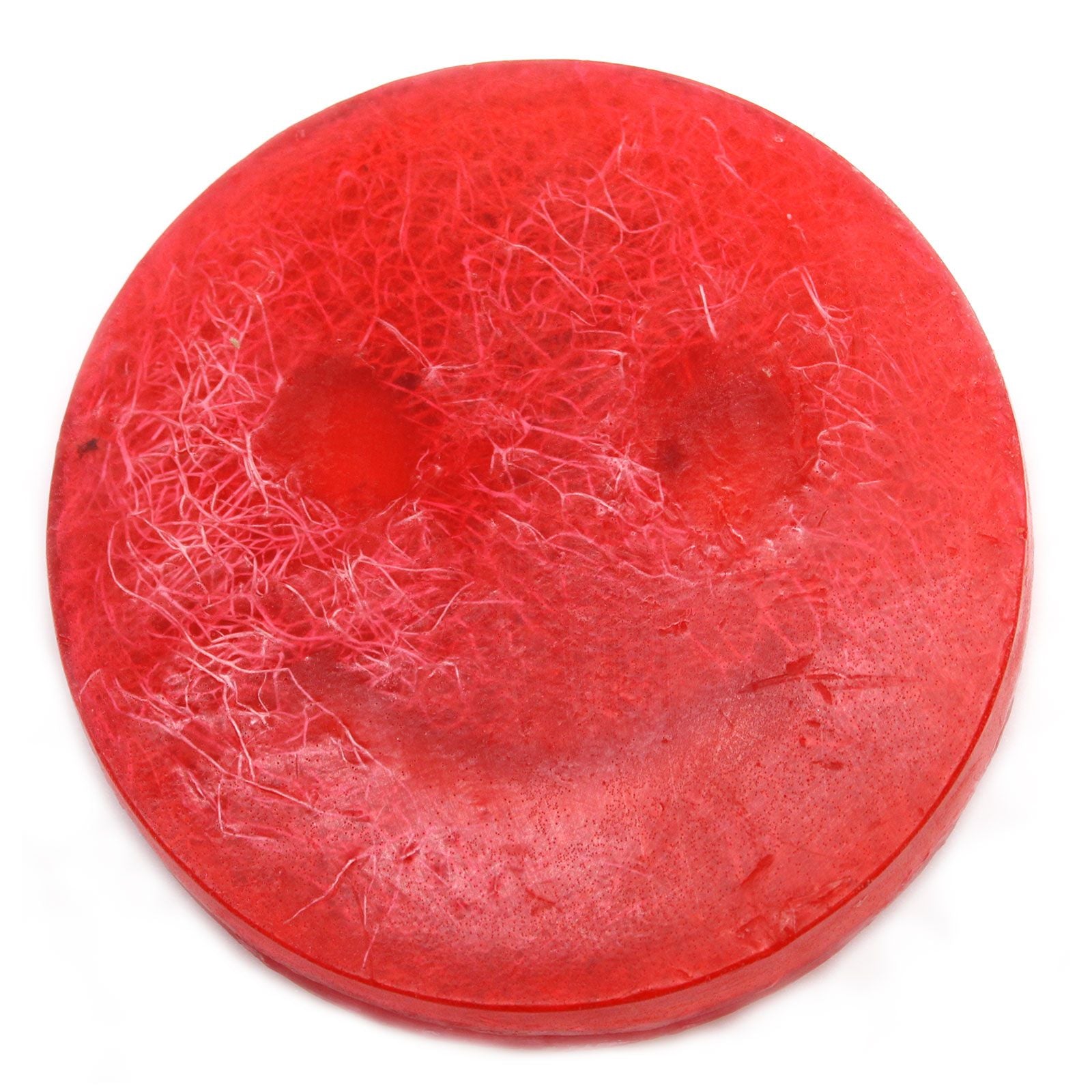 Handcrafted pink exfoliating bar soap with a textured surface and dried botanical elements.