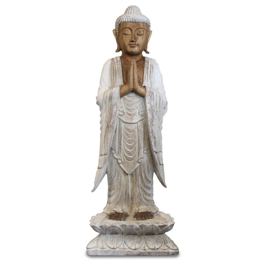 Large hand-carved standing Buddha statue with a distressed whitewash finish, positioned in a welcoming gesture.