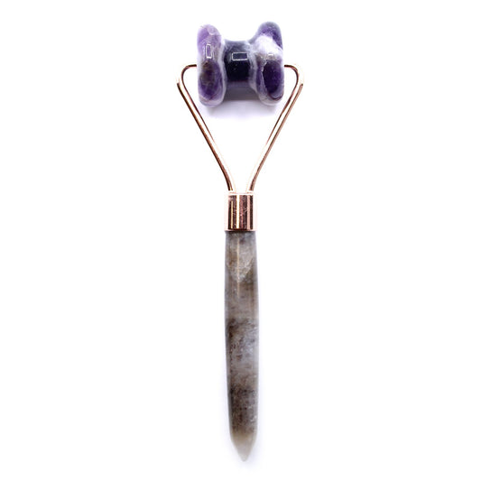 Purple amethyst gemstone facial roller with a smooth ergonomic handle designed for jawline and facial massage.