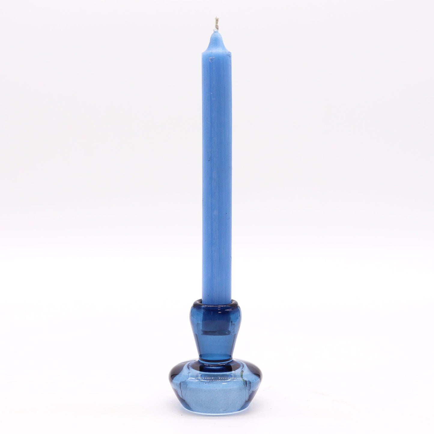 Royal blue glass candle holder with a mushroom shape that flips to hold either a taper dinner candle or a small tealight.