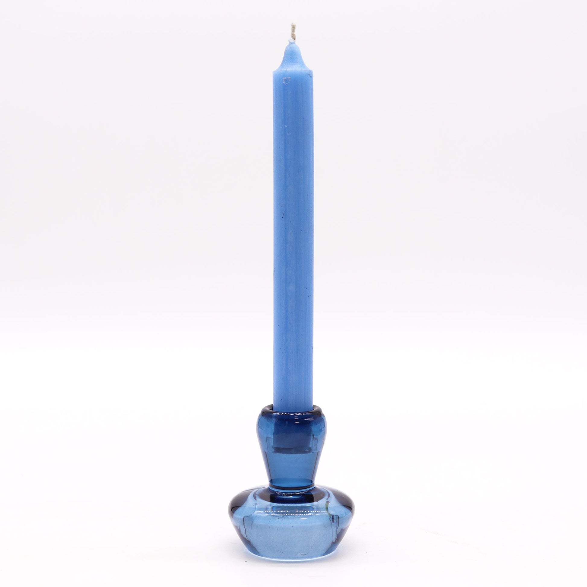 Royal blue glass candle holder with a mushroom shape that flips to hold either a taper dinner candle or a small tealight.