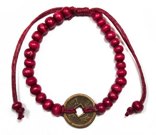 Adjustable red cord bracelet featuring dark wood beads and a traditional Chinese fortune coin for good luck.