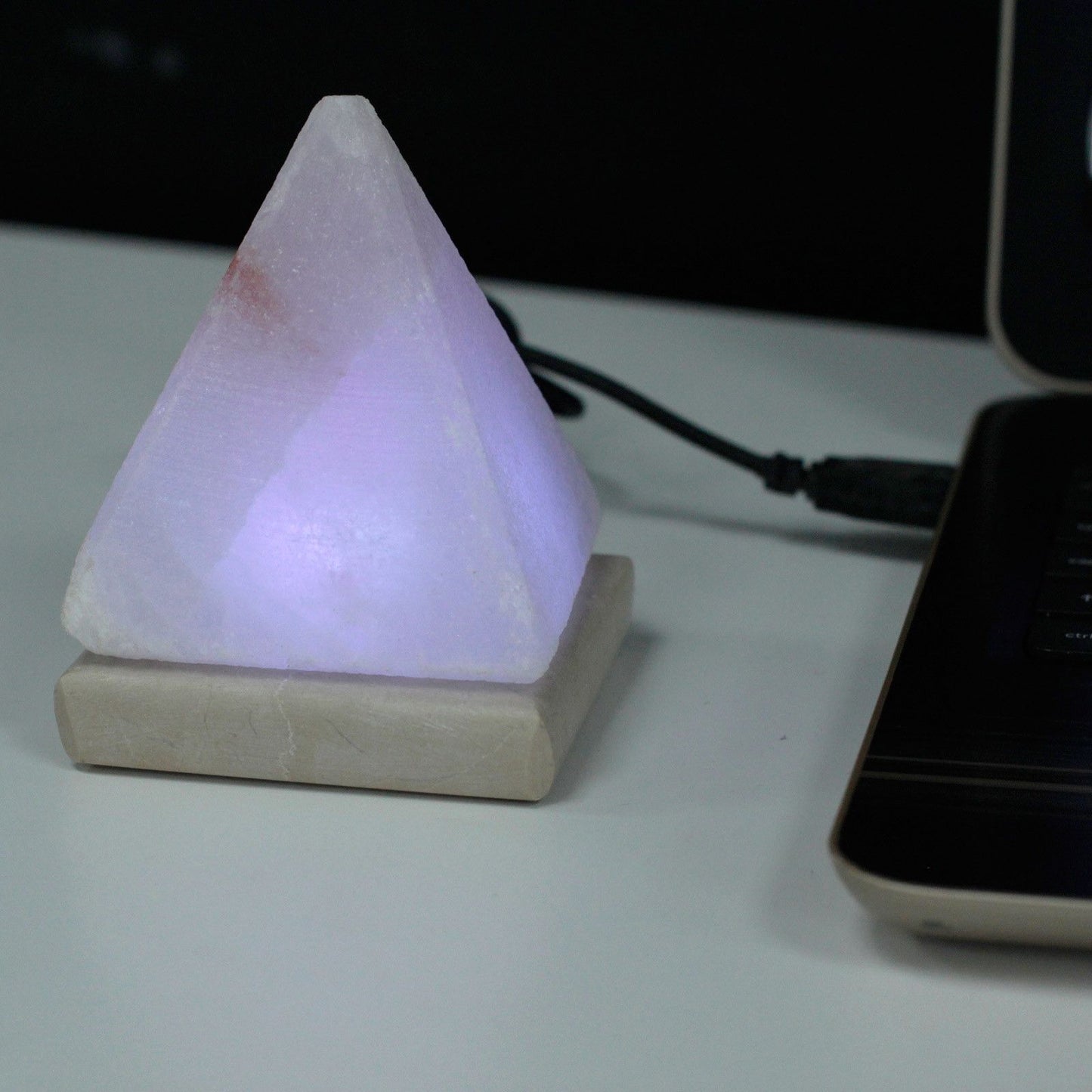 A 9cm pyramid-shaped white Himalayan salt lamp on a wooden base with a glowing multicolour LED light effect.
