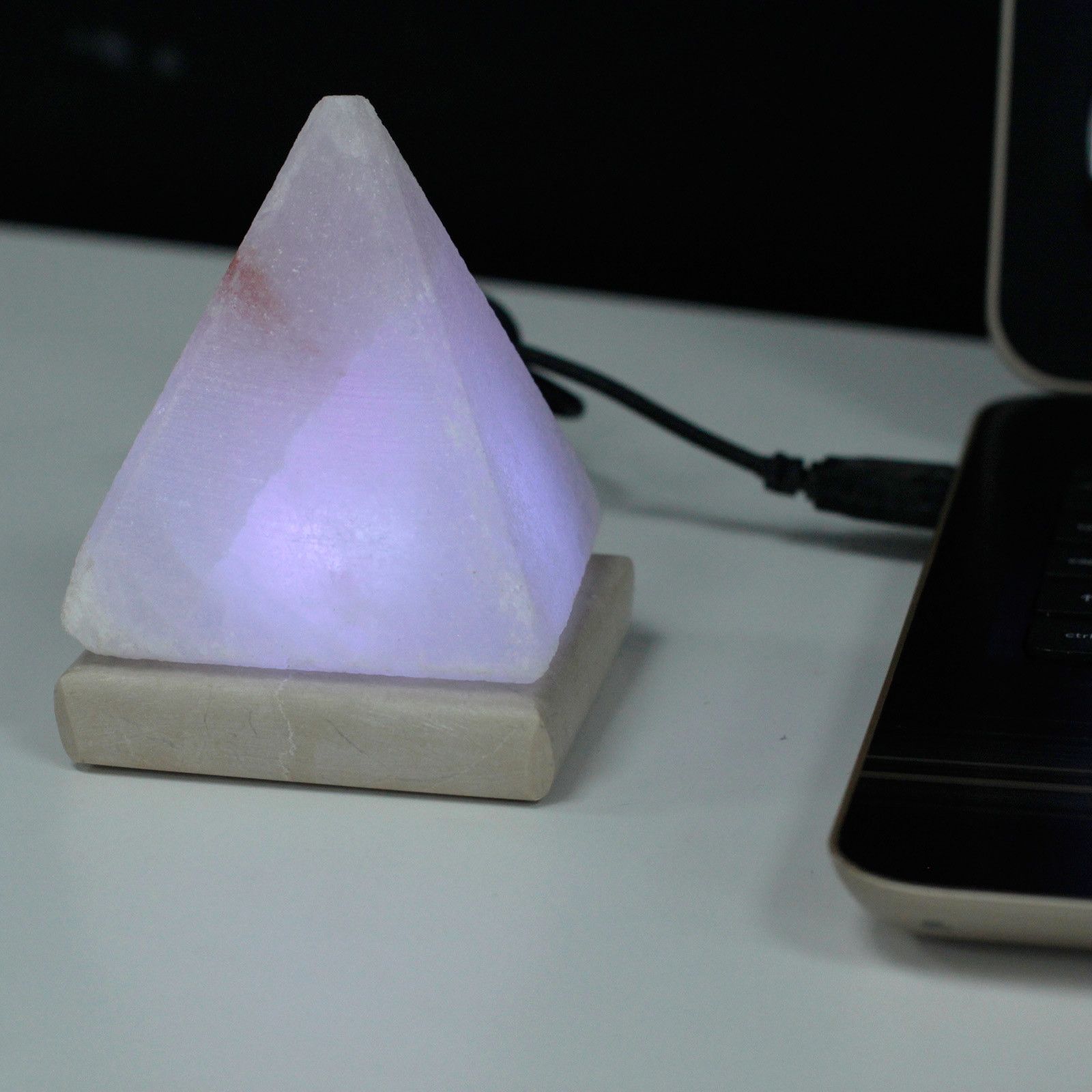 A 9cm pyramid-shaped white Himalayan salt lamp on a wooden base with a glowing multicolour LED light effect.