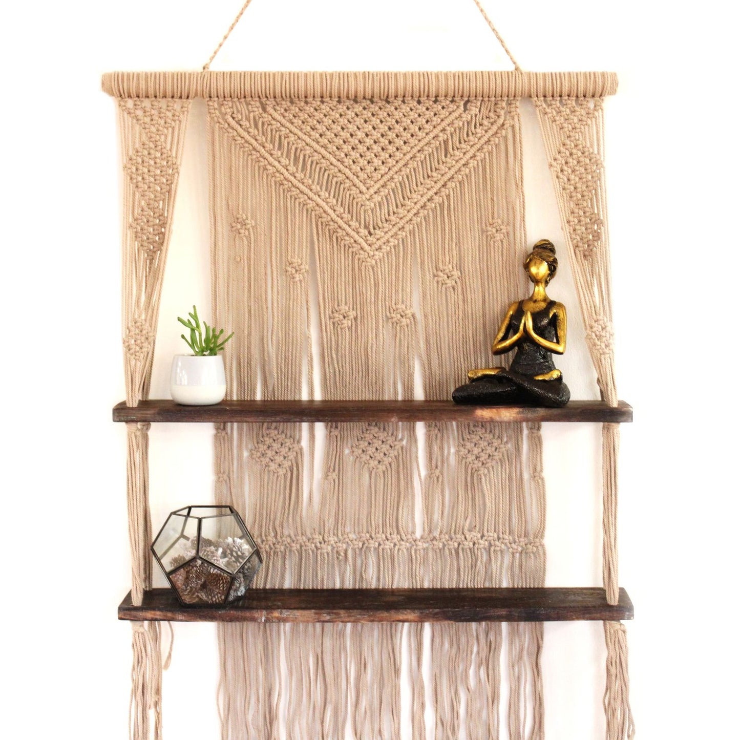 Handmade brown macrame wall hanging featuring a natural wood shelf for displaying small home decor items.