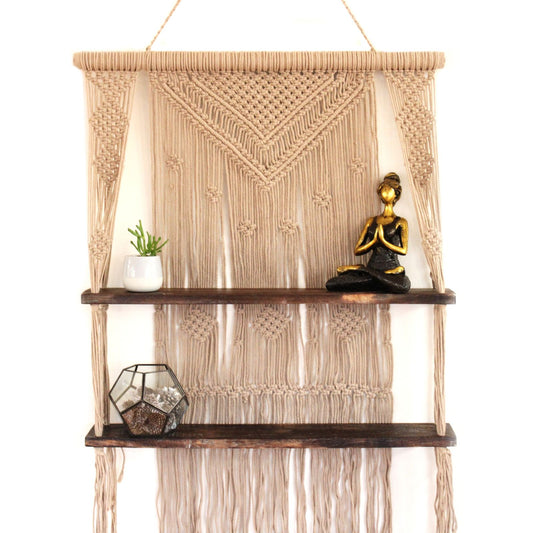 Handmade brown macrame wall hanging featuring a natural wood shelf for displaying small home decor items.
