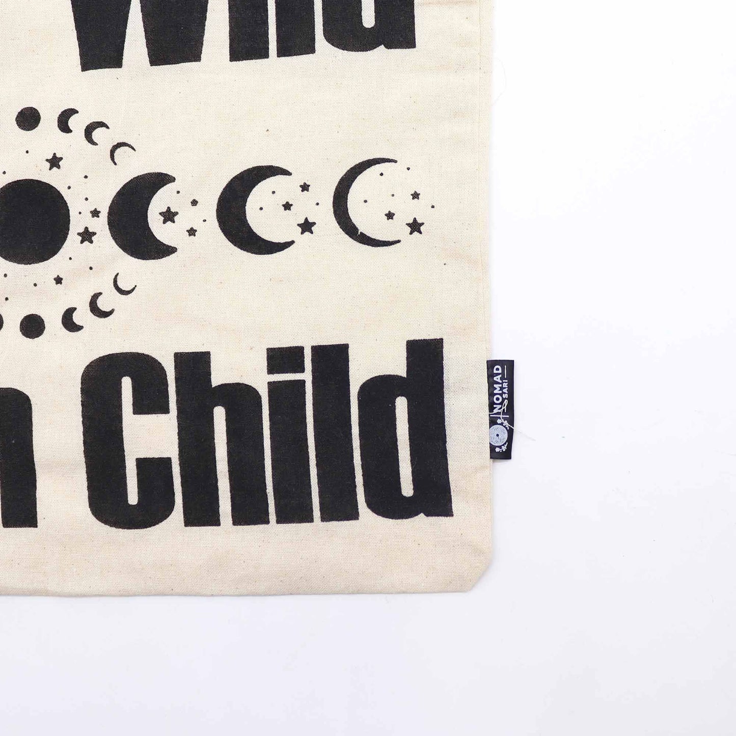 Natural cotton tote bag featuring a celestial Stay Wild, Moon Child graphic design in black ink.