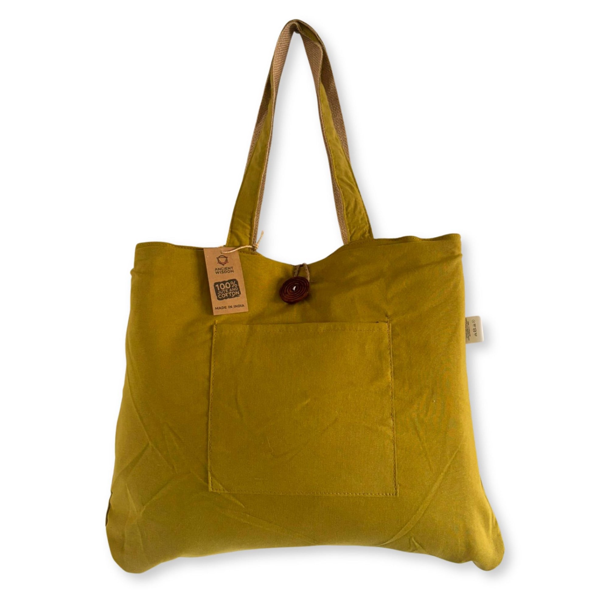 Large reversible pistachio green and cream tote bag made from woven jute and cotton with sturdy shoulder handles.