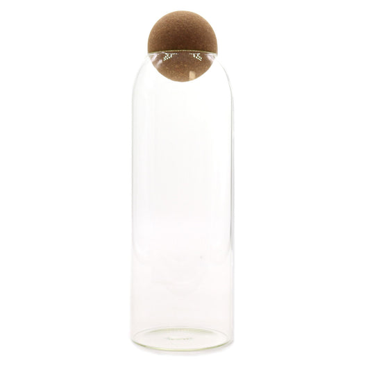 Clear glass jar with a round cork ball lid and a minimalist cottage style aesthetic.
