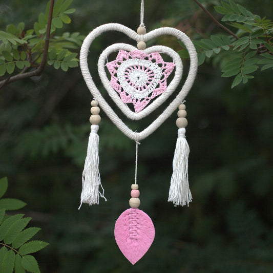 Handmade pink heart-shaped dream catcher with a double heart design and natural woven textures.