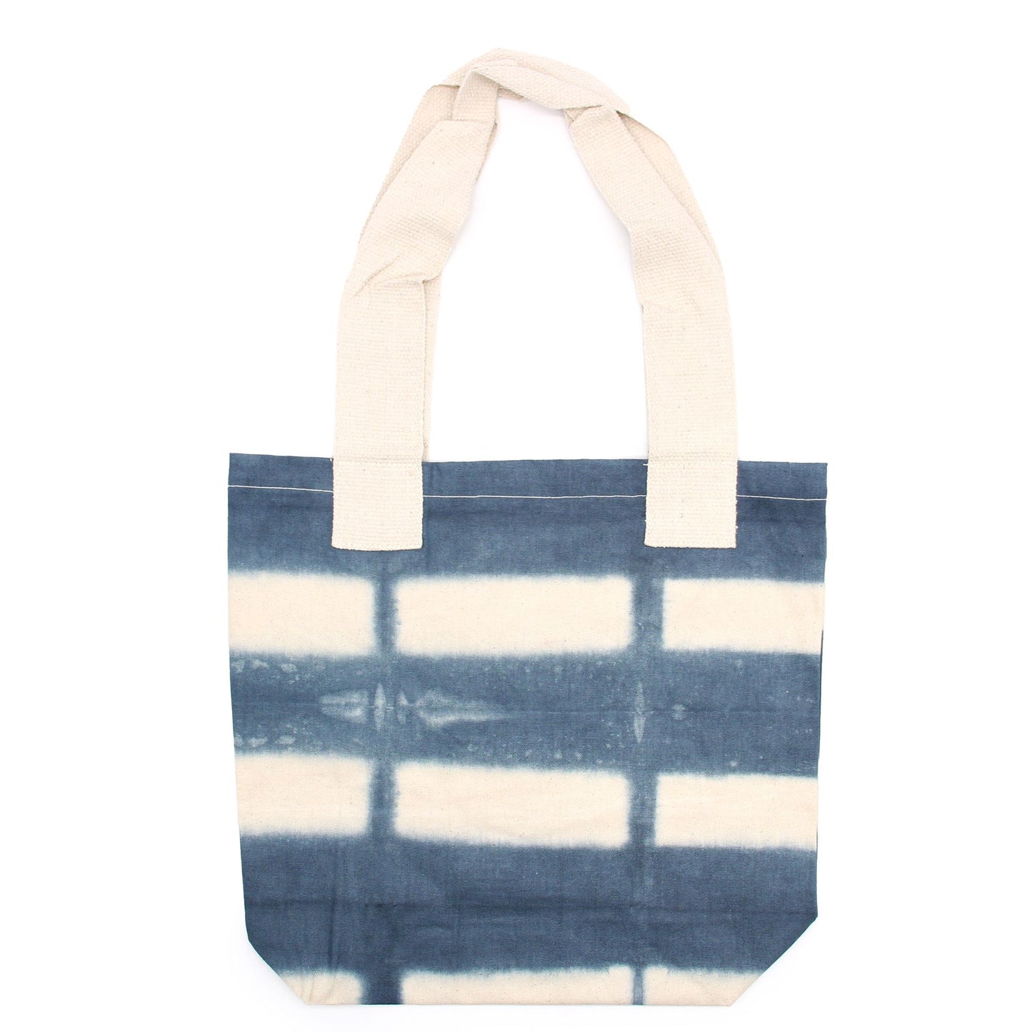 Handmade natural cotton tote bag with a unique grey block tie-dye pattern and sturdy natural fabric handles.