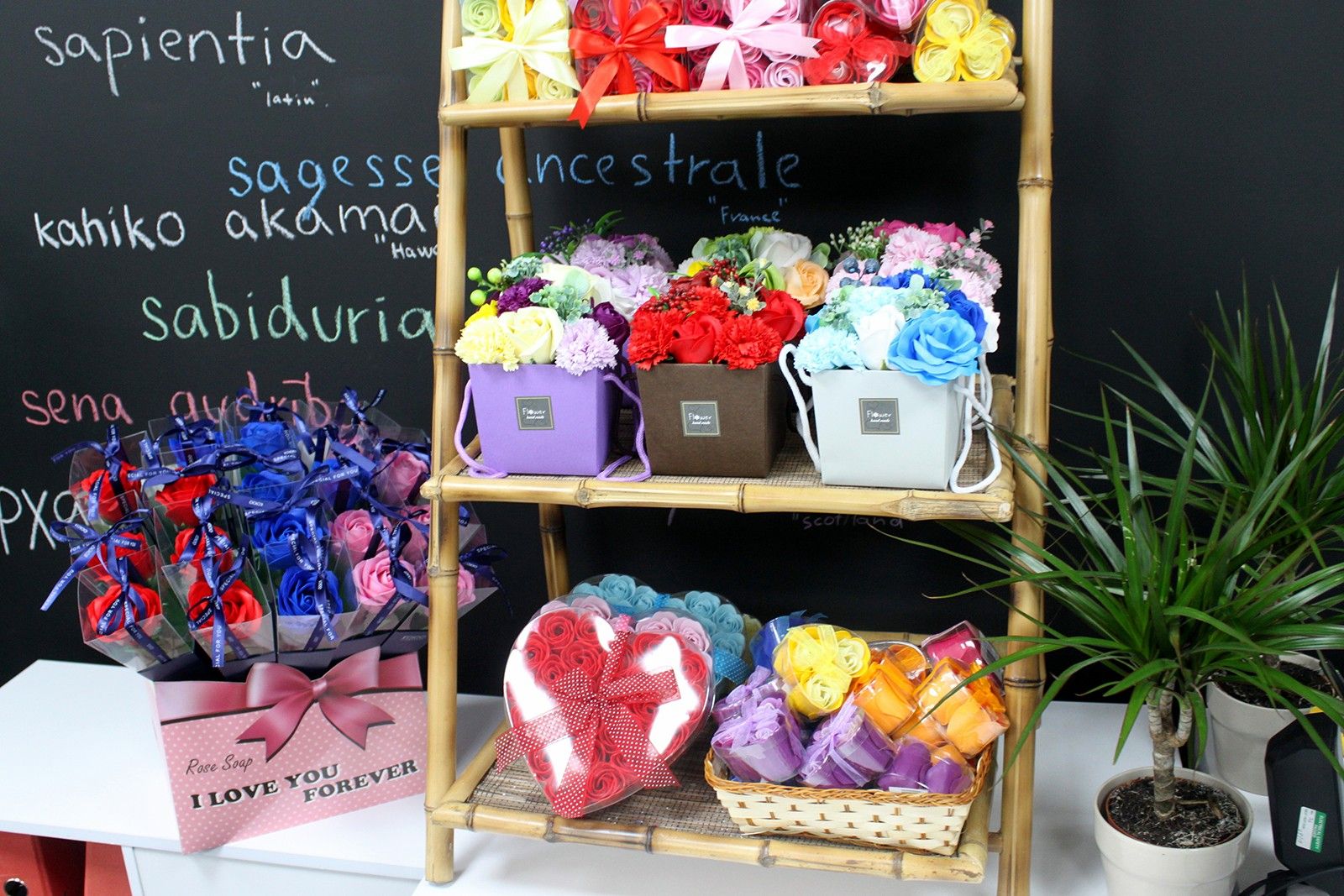Three delicate peach-coloured soap roses arranged inside a heart-shaped gift box.