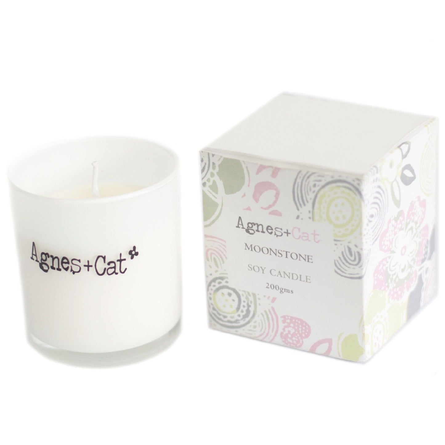 Small white soy wax votive candle in a simple glass holder with a clean, minimalist aesthetic.