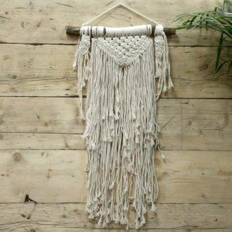 Intricately handcrafted natural cream macrame wall hanging with a minimalist boho design and fringed detailing.