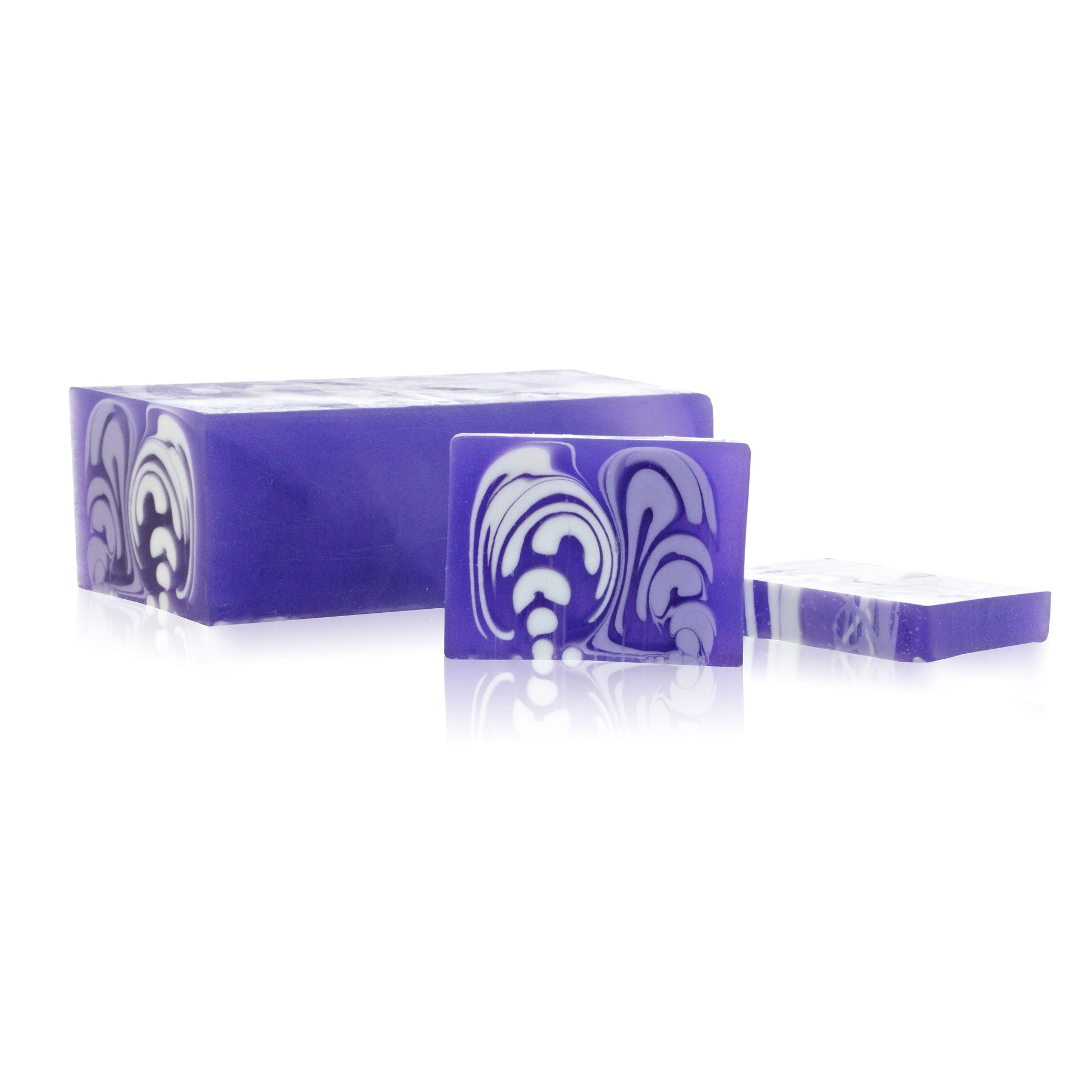 Large artisanal lavender soap loaf with a rustic textured top and purple floral hues.