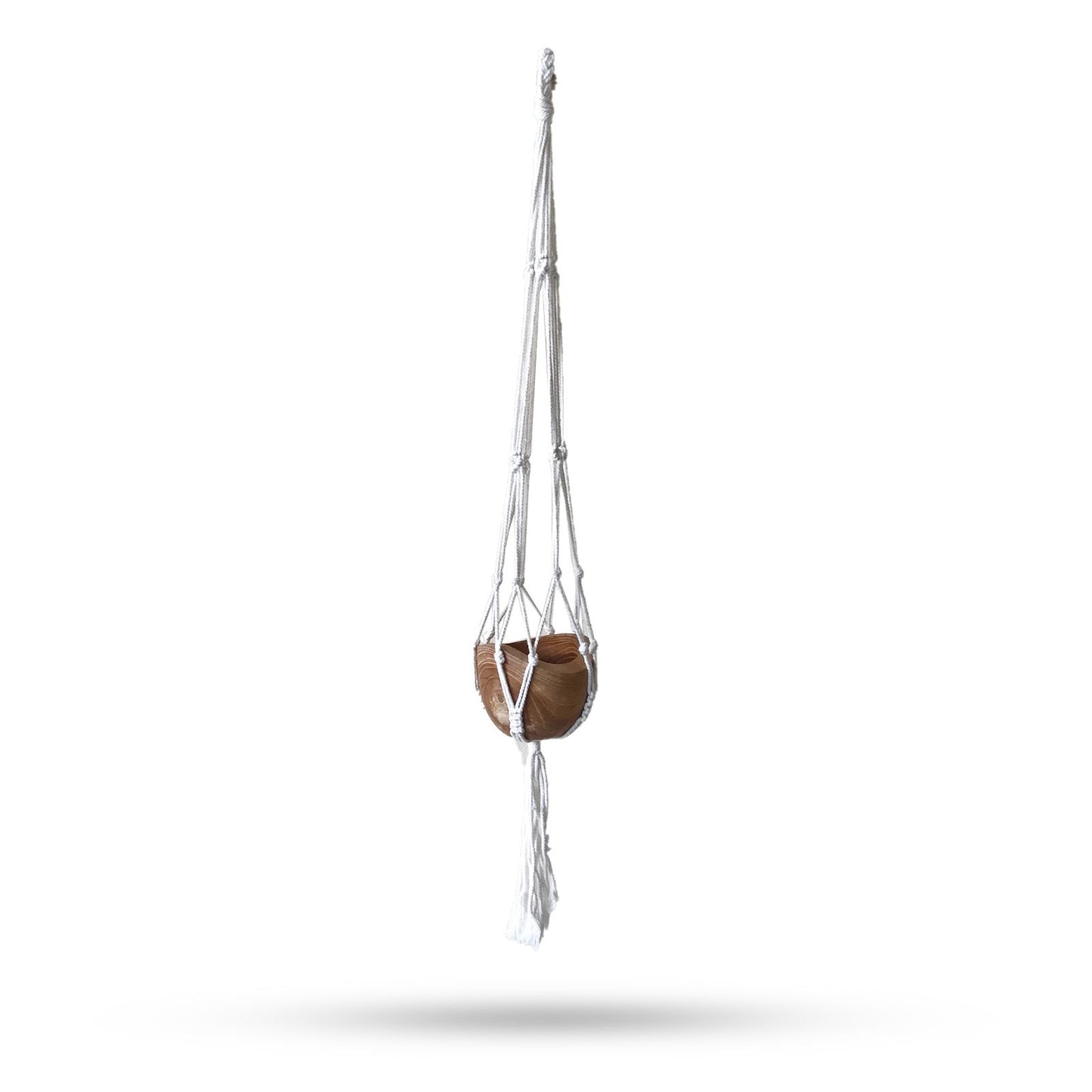 Handcrafted natural cotton macrame plant hanger with intricate knotting holding a medium-sized ceramic flower pot.