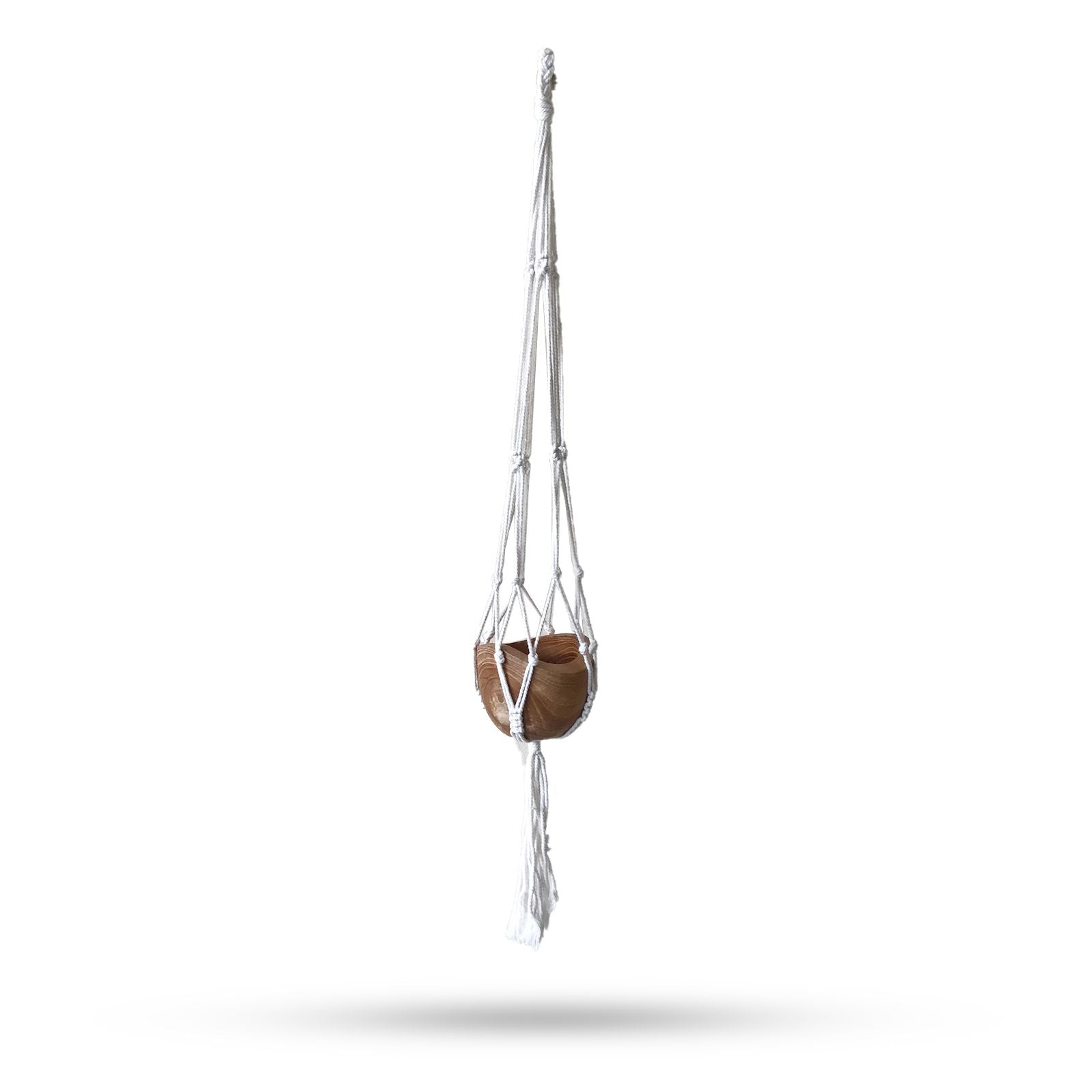 Handcrafted natural cotton macrame plant hanger with intricate knotting holding a medium-sized ceramic flower pot.
