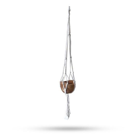 Handcrafted natural cotton macrame plant hanger with intricate knotting holding a medium-sized ceramic flower pot.