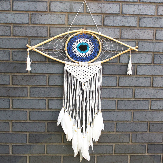 Large macrame dream catcher featuring a blue and white evil eye design with flowing black and white cotton tassels.