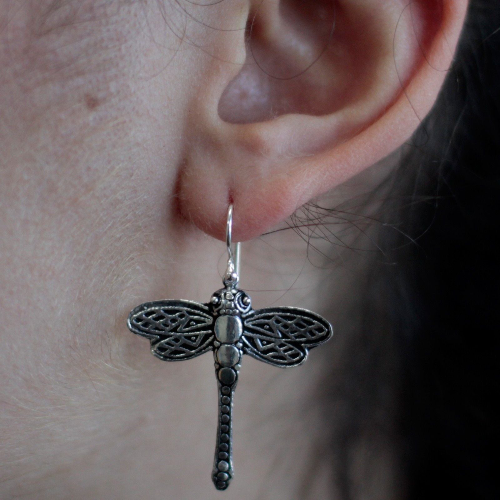 Detailed sterling silver dragonfly drop earrings featuring delicate filigree wings and a polished finish.