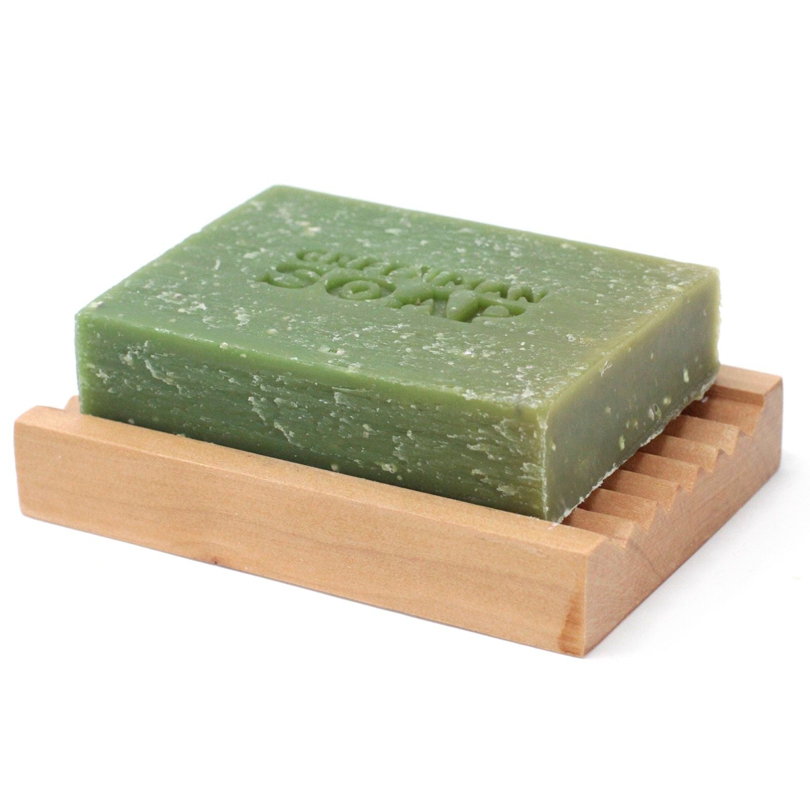 Handcrafted green soap slice with textured exfoliating pumice and botanical infusions.