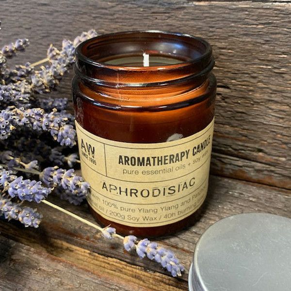 Creamy white soy wax aromatherapy candle in a glass jar with a minimalist label on a neutral background.