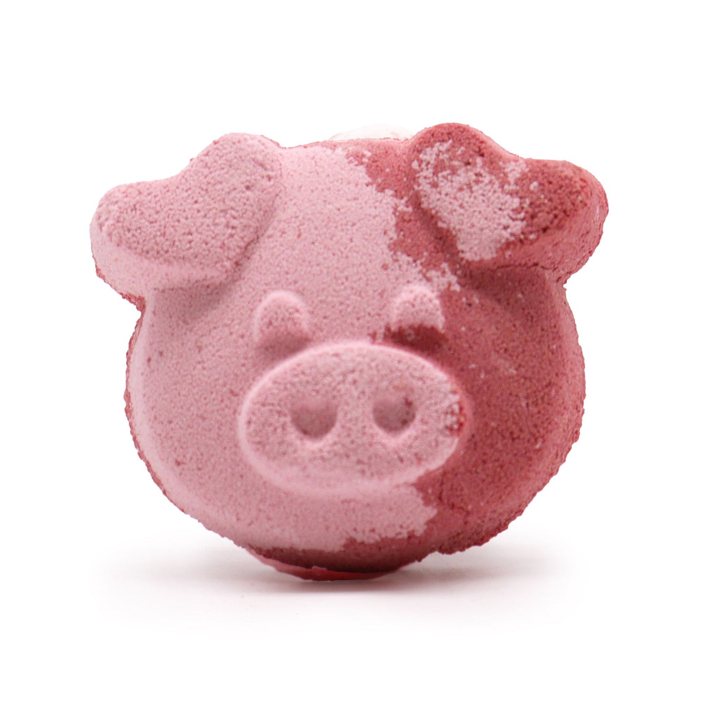 Cute pink pig shaped bath bomb with a detailed face and small ears on a plain background.